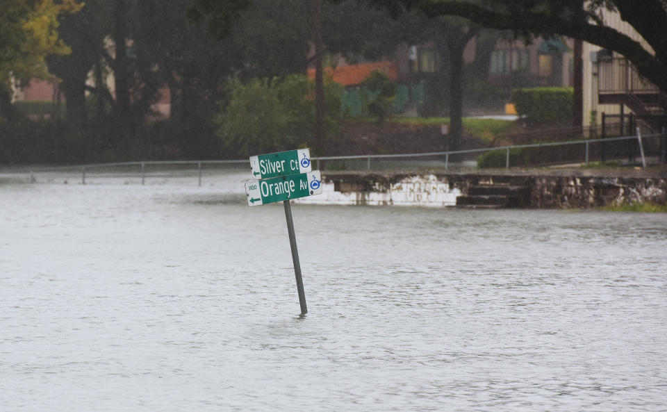 A street sign stands in a road flooded by heavy rain from Tropical Storm Ian on September 29, 2022 in Orlando, Florida. / Credit: Paul Hennessy/Anadolu Agency via Getty Images