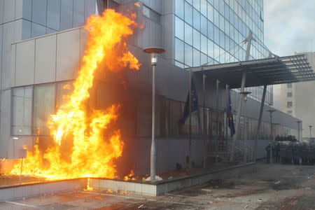 A government building is seen on fire during a protest in Kosovo's capital Pristina, January 9, 2016. REUTERS/Hazir Reka