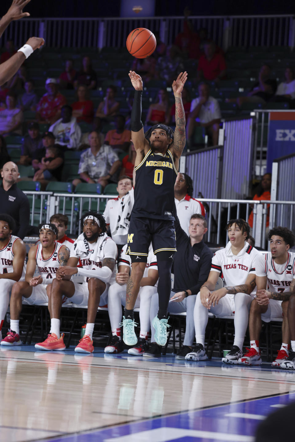 In a photo provided by Bahamas Visual Services, Michigan's Dug McDaniel shoots against Texas Tech during the first half of an NCAA college basketball game in the Battle 4 Atlantis at Paradise Island, Bahamas, Friday, Nov. 24, 2023. (Tim Aylen/Bahamas Visual Services via AP)