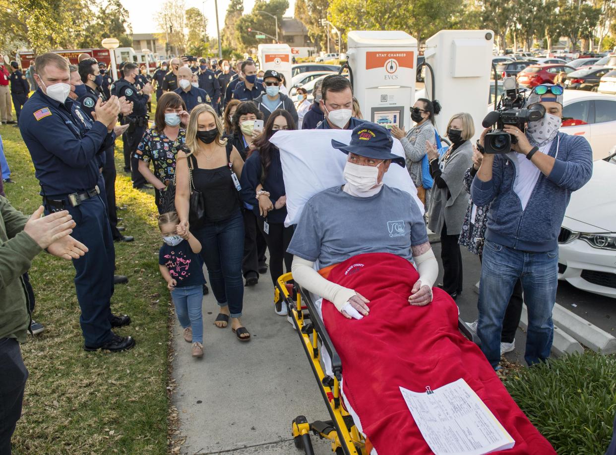 Dylan Van Iwaarden, an Orange County Fire Authority hand crew firefighter, is wheeled on a gurney as he leaves the Orange County Global Medical Center.