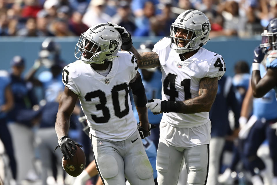 Las Vegas Raiders safety Duron Harmon (30) is congratulated by Matthias Farley (41) after Harmon intercepted a pass against the Tennessee Titans in the second half of an NFL football game Sunday, Sept. 25, 2022, in Nashville, Tenn. (AP Photo/Mark Zaleski)