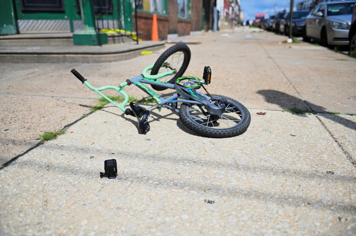 A bicycle is pictured at the scene as investigations are ongoing the day after a mass shooting in the Kingsessing section of southwest Philadelphia, Pennsylvania (Reuters)