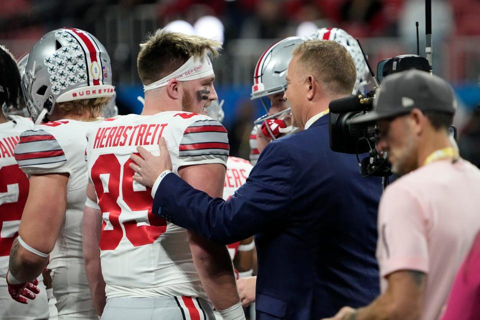 ESPN announcer Kirk Herbstreit talks to his son, Ohio State tight end Zak Herbstreit (89), prior to the Peach Bowl at Mercedes-Benz Stadium. (Adam Cairns/Columbus Dispatch)