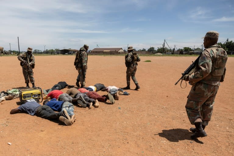 South African soldiers guard detained suspects in the fight against illegal mining in Kagiso, Gauteng Province (WIKUS DE WET)