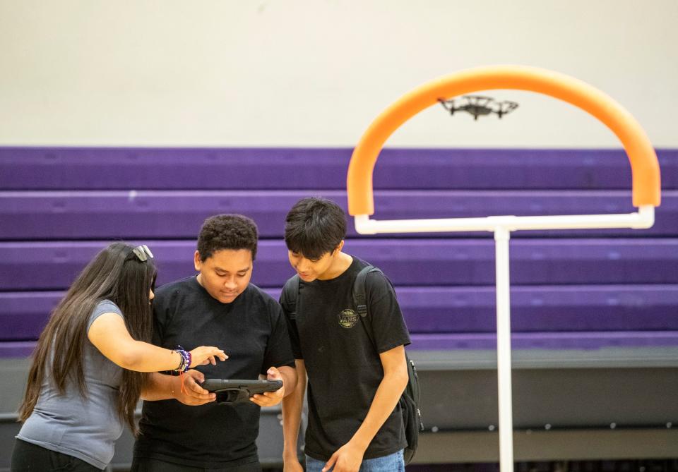 Students work together while learning to fly a drone through an obstacle course at Painted Hills Middle School in Desert Hot Springs, Calif., Friday, June 24, 2022. 