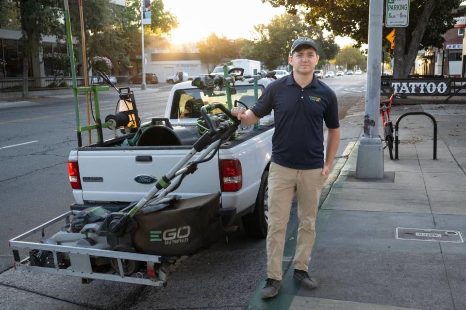 Iggy Artemenko, owner of Lawn Care Up, stands with the battery powered equipment used by his workers on Sept. 5 on Broadway in Sacramento. The company has been running the all-electric yard care service for two years. Artemenko said he feels price of running electric equipment is about the same as gas, since he doesn’t have to pay for fuel and charges the batteries with a solar panel at his shop.