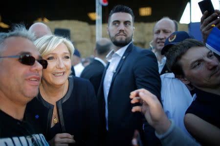 Marine Le Pen, French National Front (FN) political party leader and candidate for French 2017 presidential election, poses with a supporter after a political rally in Pageas, France April 13, 2017. REUTERS/Stephane Mahe