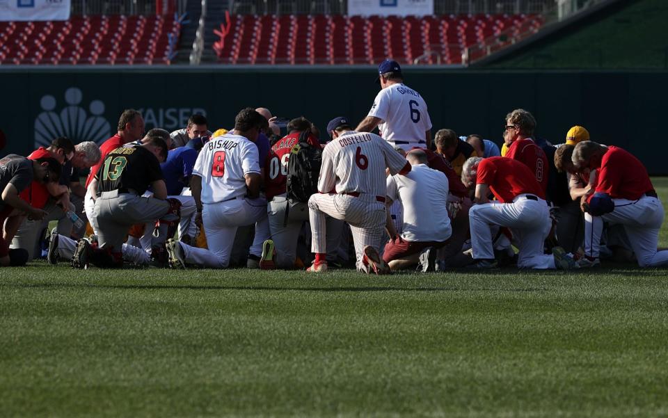 Members of congress pray ahead of their baseball game - Getty Images North America