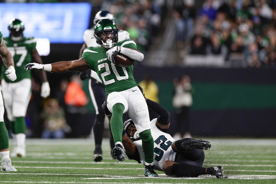 New York Jets' Breece Hall (20), left, is tackled by Philadelphia Eagles' Zach Cunningham during the second half of an NFL football game, Sunday, Oct. 15, 2023, in East Rutherford, N.J. (AP Photo/Adam Hunger)