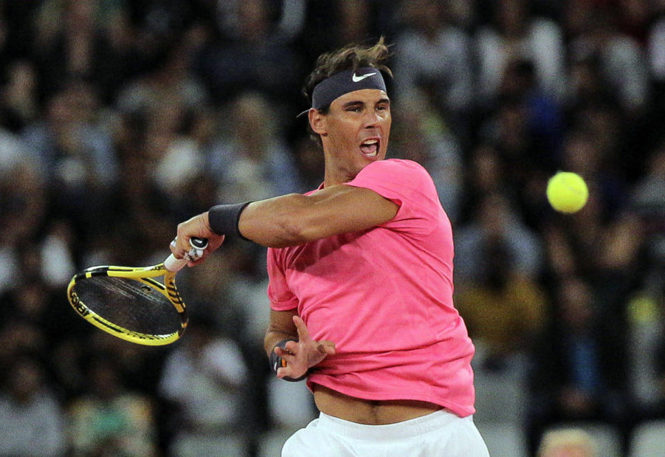 Rafael Nadal in action during the exhibition tennis match against Roger Federer, held at the Cape Town Stadium in Cape Town, South Africa, Friday Feb. 7, 2020. (AP Photo/Halden Krog)