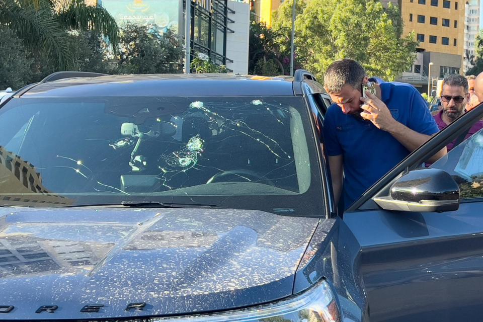 Police officers inspect a car inside of which a hand-held pager exploded, Beirut, Lebanon, Tuesday, Sept. 17, 2024. (AP Photo/Hussein Malla) (Hussein Malla/AP)