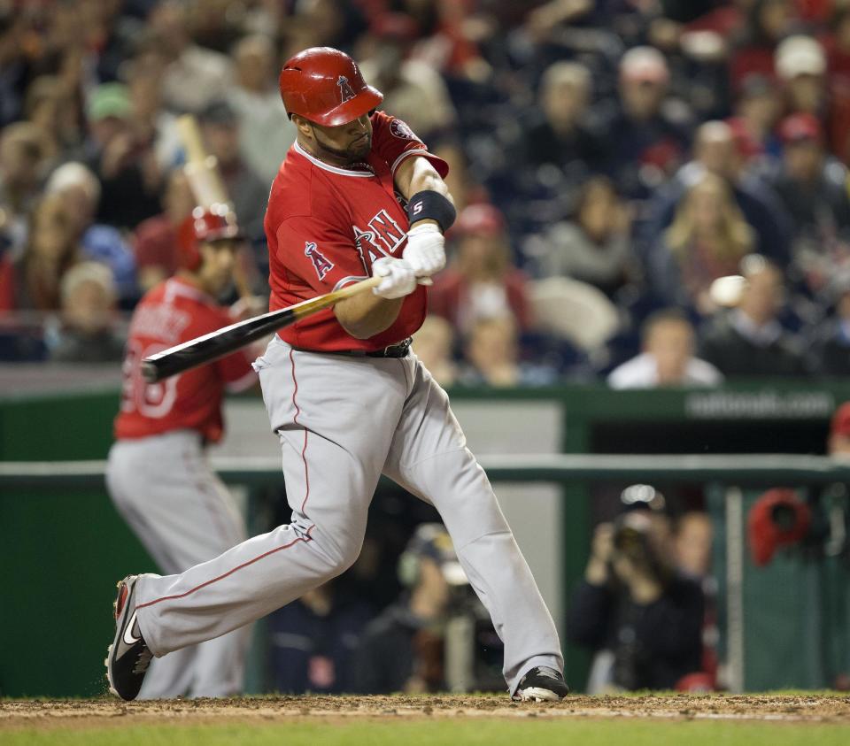 Los Angeles Angels Albert Pujols connects for a two-run homer against Washington Nationals Taylor Jordan in the fifth inning of a baseball game in Washington, Tuesday, April 22, 2014. This was Pujols 500th career home run. (AP Photo/Pablo Martinez Monsivais)