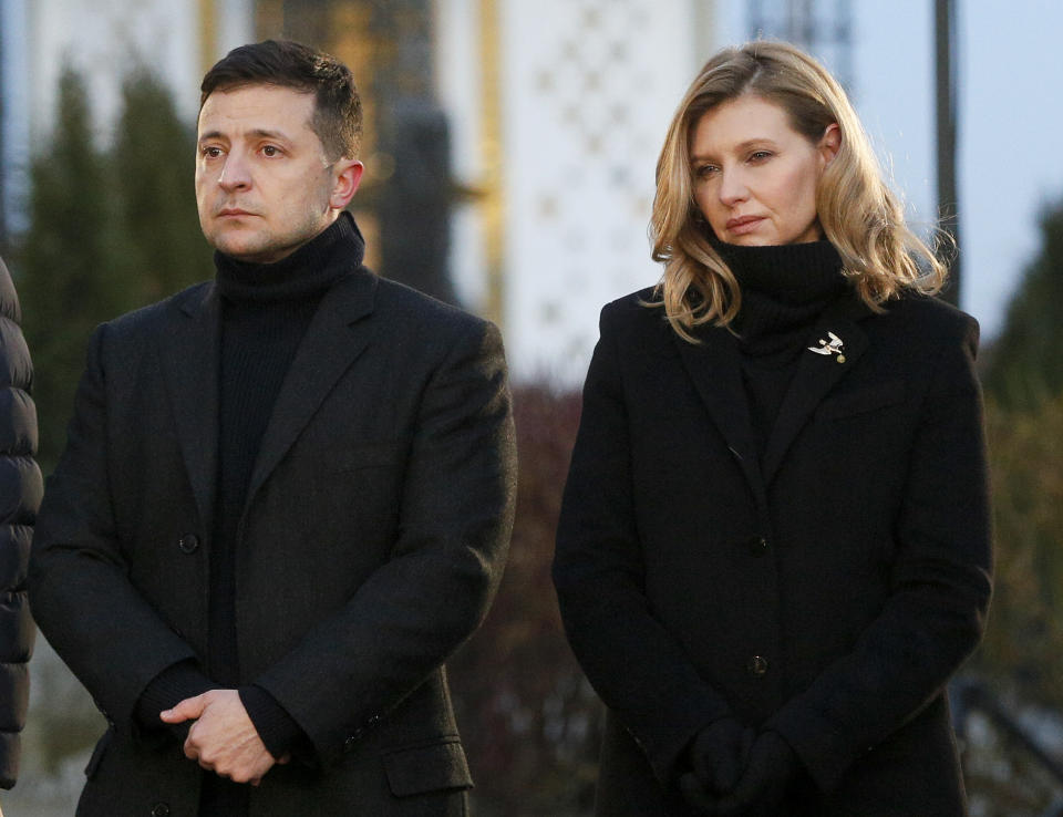 FILE - In this file photo taken on Saturday, Nov. 23, 2019, President Volodymyr Zelenskiy and his wife Olena pay tribute at a monument to victims of the Great Famine in Kyiv, Ukraine. Olena Zelenska, the wife of Ukraine's President Volodymyr Zelenskiy, announced Friday she tested positive for the coronavirus. ( AP Photo/Efrem Lukatsky, FILE)