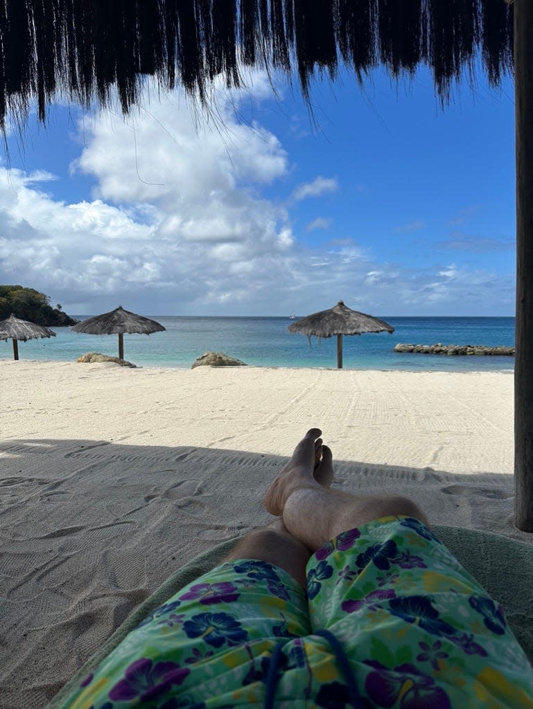 view of man's legs on a beach canouan