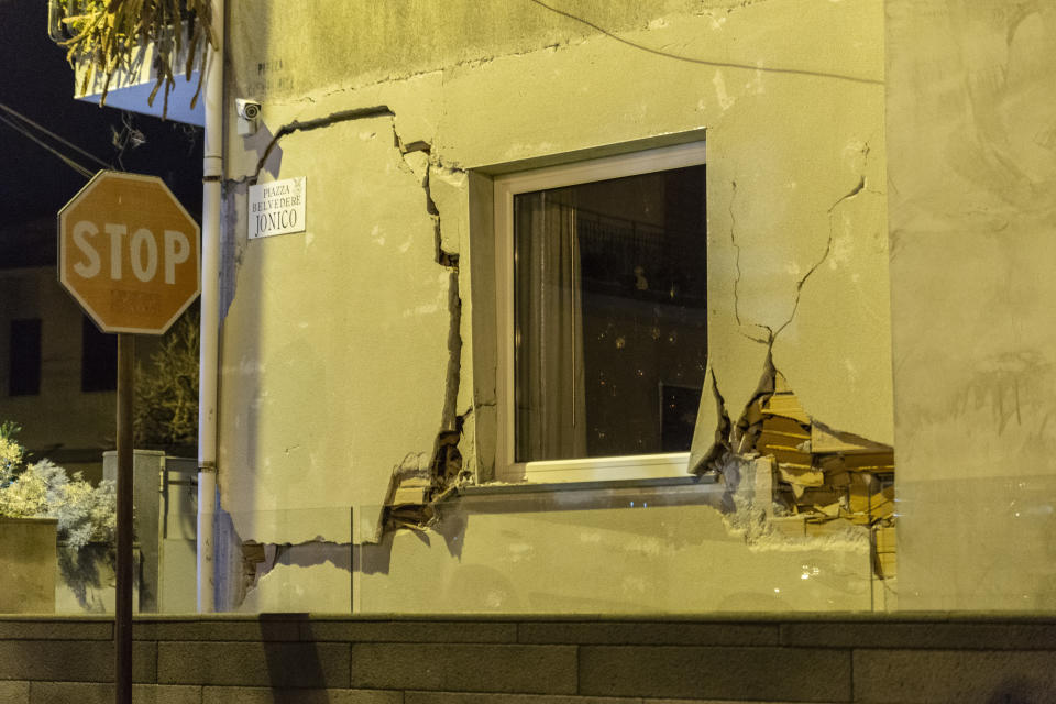 Cracks are seen on a wall of a damaged house in Fleri, Sicily Italy, Wednesday, Dec. 26, 2018. A quake triggered by Italy's Mount Etna volcano has jolted eastern Sicily, slightly injuring 10 people and prompting frightened Italian villagers to flee their homes. (AP Photo/Salvatore Allegra)