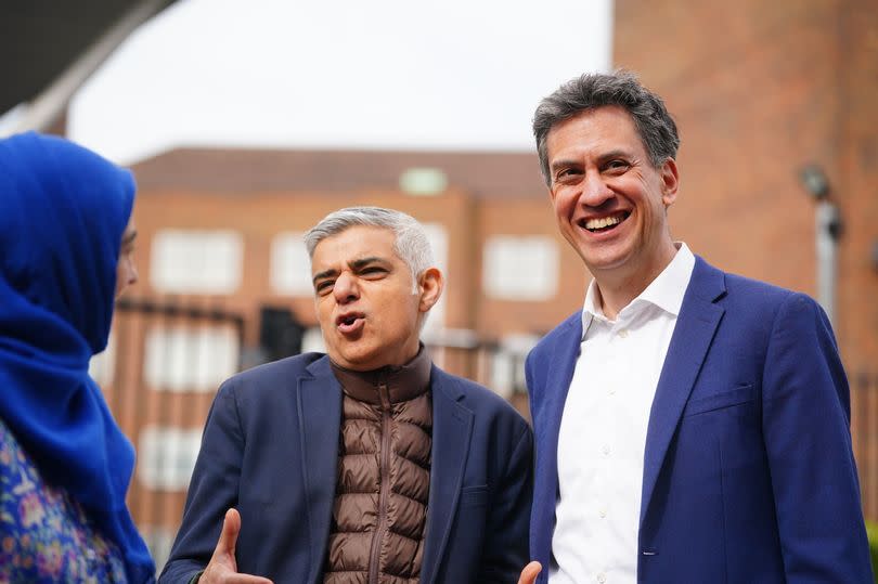 Mayor of London Sadiq Khan (centre) and shadow energy secretary Ed Miliband, during a visit to Stoke Newington School