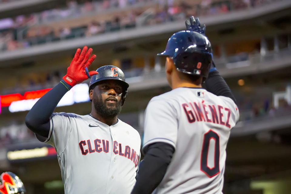 Franmil Reyes, left, is congratulated by Guardians' Andres Gimenez after hitting a two-run homer for the Guardians against the Twins in the eighth inning Tuesday, June 21, 2022, in Minneapolis. (AP Photo/Andy Clayton-King)