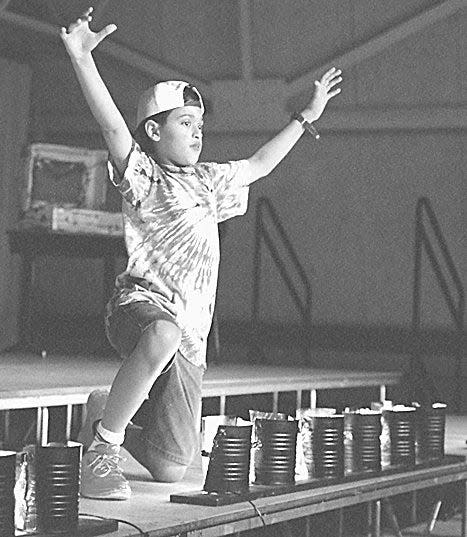 Vivek Ramaswamy pictured in The Enquirer in 1997. The caption reads, "Vivek Ramaswamy makes his debut as an opera singer performing 'My Life Is Great.' The students made the stage lights from coffee cans."