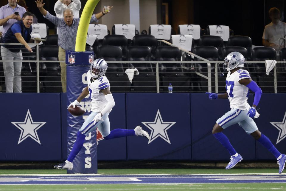 Dallas Cowboys cornerback Trevon Diggs (7) and safety Jayron Kearse (27) celebrate after Diggs intercepted a Philadelphia Eagles' Jalen Hurts pass and returned it for a touchdown in the second half of an NFL football game in Arlington, Texas, Monday, Sept. 27, 2021. (AP Photo/Ron Jenkins)