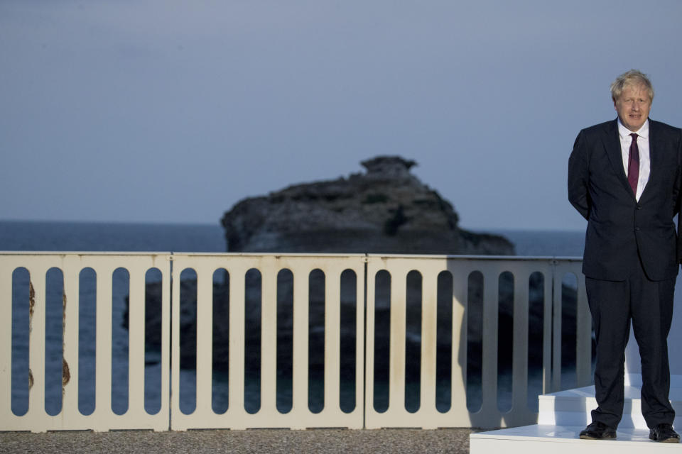 British Prime Minister Boris Johnson poses for the G-7 family photo at G-7 summit at the Hotel du Palais in Biarritz, France, Sunday, Aug. 25, 2019. (AP Photo/Andrew Harnik)