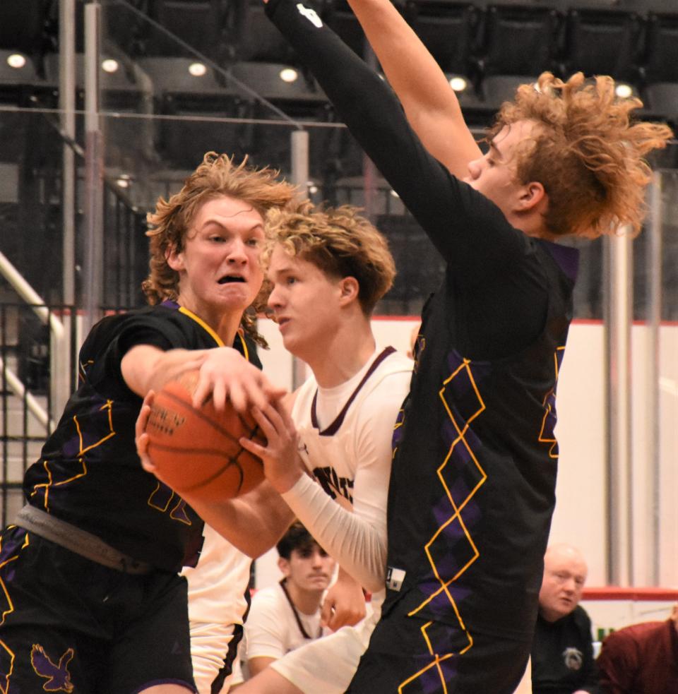 Frankfort-Schuyler Maroon Knight Dennis Waugh works his way between Duanesburg defenders Evan Williams and Ethan Thompson (from left) Thursday at the Downtown Classic in the Nexus Center in Utica.