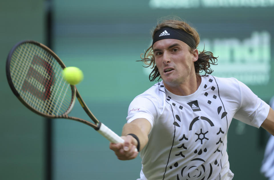 Stefanos Tsitsipas of Greece returns to France's Benjamin Bonzi during their match at the ATP tennis tournament in Halle, Germany, Tuesday, June 14, 2022. (Friso Gentsch/dpa via AP)