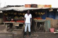 <h2>Selling vegetables in Nairobi</h2>Karl Moi Okoth, a 27 year-old vegetable and fruit seller, poses for a picture in front of his makeshift shop in Nairobi's Kibera slum in the Kenyan capital April 30, 2012. Okoth studied psychology and chemistry at Day Star University where he received a degree in psychology. He has been searching for permanent employment for four years but has decided to make a living working in the slums for the last eight months.