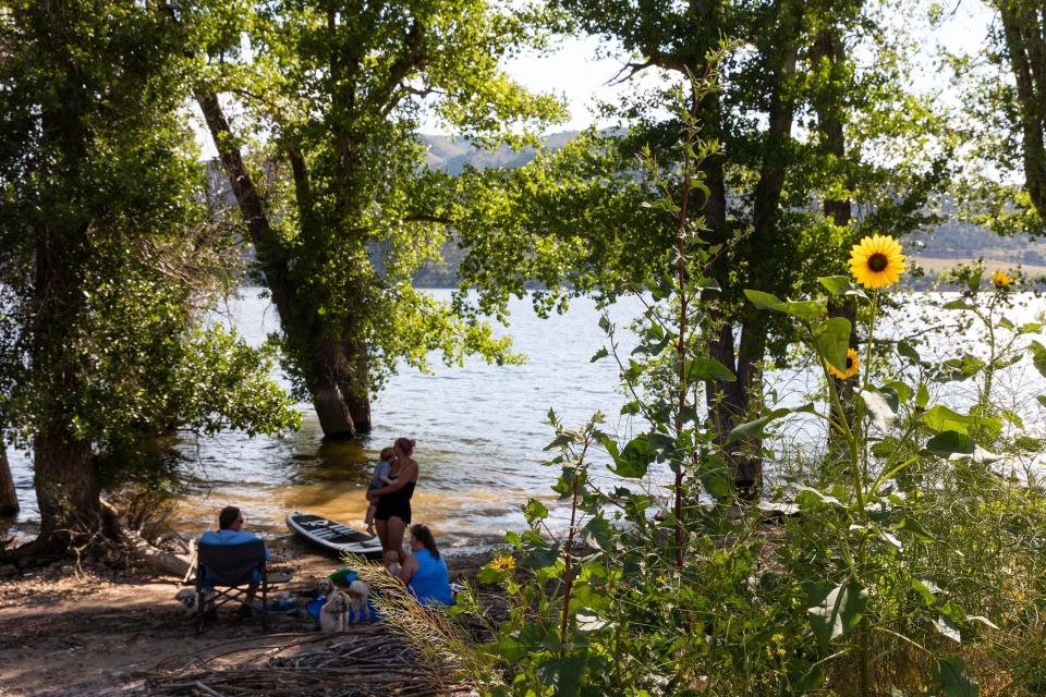 The Pectol family, from Centerville and Woods Cross, hang out in the shade at Echo State Park in Coalville on Monday, July 17, 2023. | Megan Nielsen, Deseret News