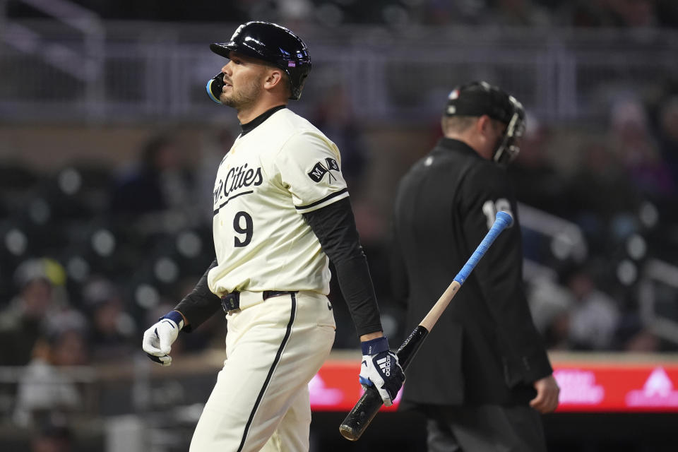 Minnesota Twins' Trevor Larnach (9) walks back to the dugout after striking out against the Detroit Tigers during the sixth inning of a baseball game Friday, April 19, 2024, in Minneapolis. (AP Photo/Abbie Parr)