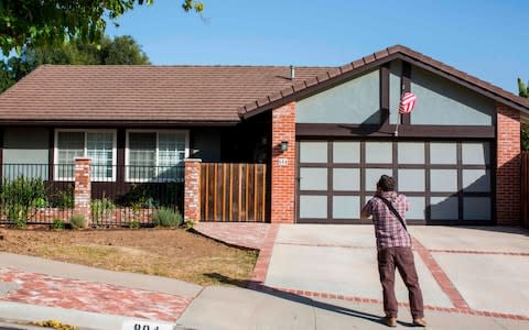 A photographer takes pictures of the home of suspected nightclub shooter Ian David Long in Thousand Oaks - Credit: AFP