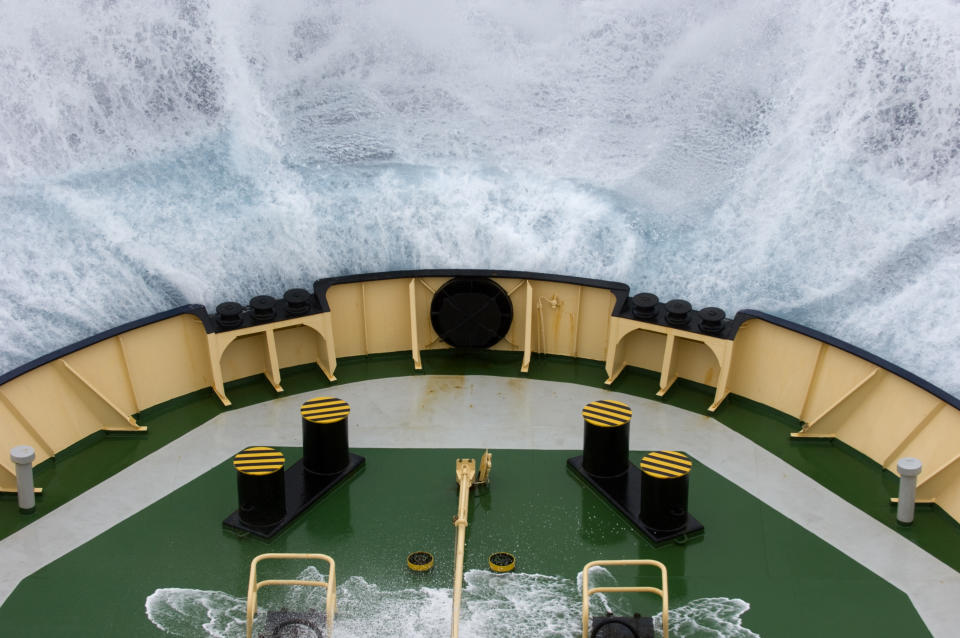 Waves crash onto an icebreaker boat in the Drake Passage