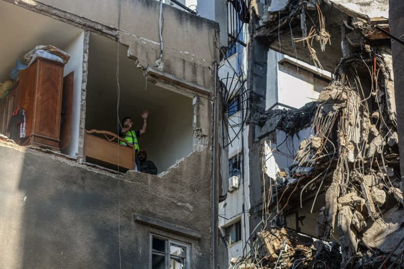 Civil defence workers inspect a destroyed apartment in a building that was targeted by an Israeli drone in Beirut's southern suburb. 4 people were killed and wounding more than 70 people. The Israeli military said Tuesday it has carried out a "targeted attack" on a commander of the pro-Iranian Hezbollah militia in Beirut.  The explosion occurred three days after a deadly rocket attack on the Israeli-occupied Golan Heights. Marwan Naamani/dpa