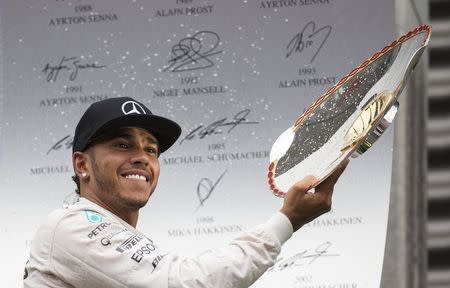 Mercedes Formula One driver Lewis Hamilton of Britain (L) celebrates his victory in the Belgian F1 Grand Prix in Spa-Francorchamps August 23, 2015. REUTERS/Yves Herman