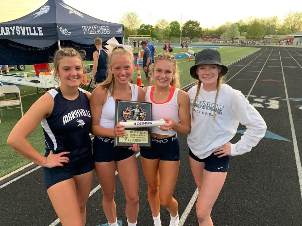 From left: Marysville girls track & field's Lauren Wilson, Reese Powers, Hannah Fisher and Alanna Dedenbach pose with the trophy after winning the Marysville Invitational at Walt Braun Viking Stadium on Friday, May 13, 2022.