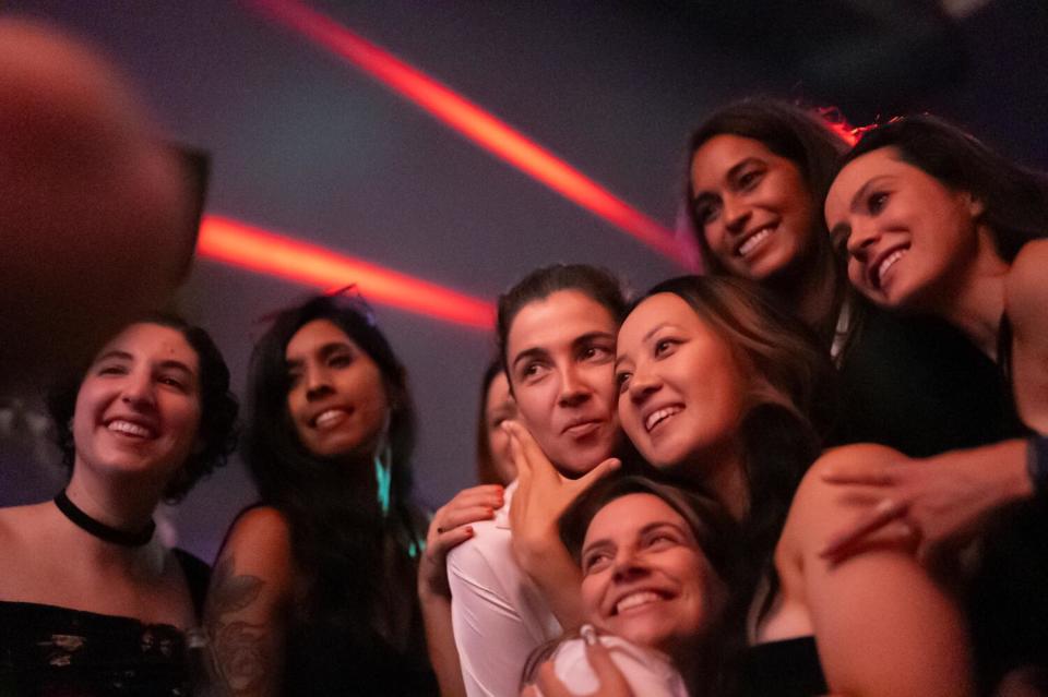 Patrons pose for a picture during Queer Prom night at Mother bar in San Francisco.