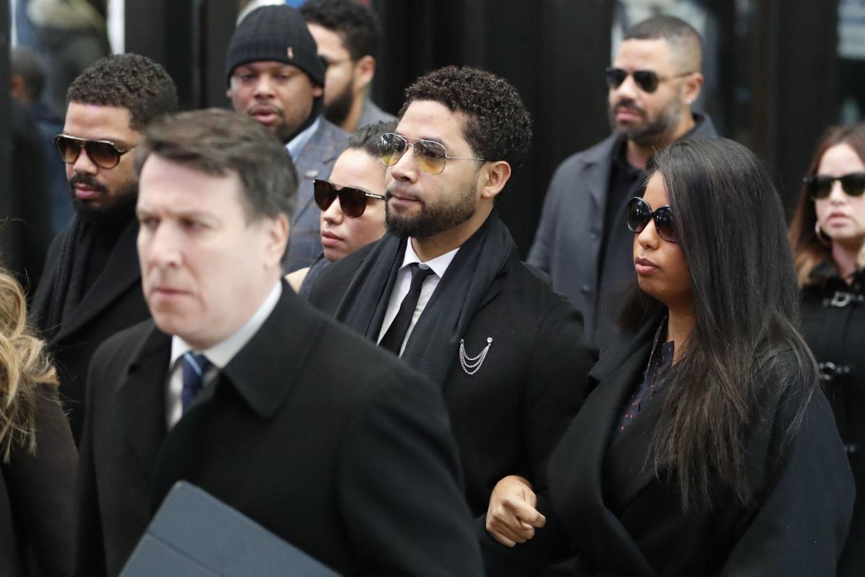 Former "Empire" actor Jussie Smollett, center, arrives for an initial court appearance on Monday, Feb. 24, 2020, at the Leighton Criminal Courthouse in Chicago, on a new set of charges alleging that he lied to police about being targeted in a racist and homophobic attack in downtown Chicago early last year.