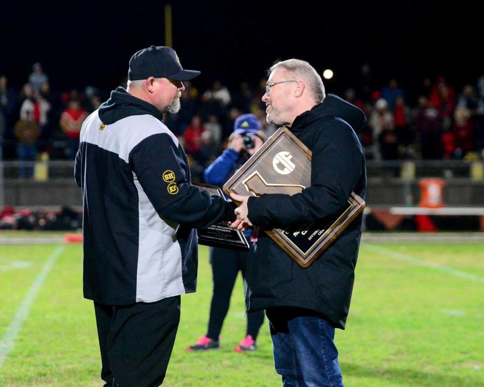 Hughson head coach Shaun King accepts the CIF Northern California Bowl Game runner up plaque from Sac-Joaquin Section Assistant Commissioner Will DeBoard after the 2023 CIF Division 4-A Northern California Bowl game between Hughson and Palma at Hughson High School in Hughson, Calif. on Saturday, Dec. 2, 2023. Palma won the game 31-21.