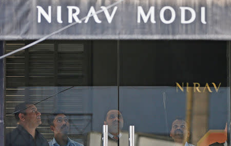 Security guards stand inside a Nirav Modi showroom during a raid by the Enforcement Directorate, a government agency that fights financial crime, in New Delhi, India, February 15, 2018. REUTERS/Adnan Abidi