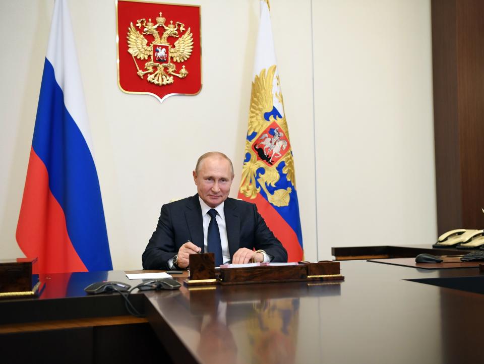 Russian President Vladimir Putin, smiles during a meeting via teleconference at the Novo-Ogaryovo residence outside Moscow, Russia, Monday, June 1, 2020. Putin set a nationwide vote on constitutional amendments allowing him to extend his rule for July 1. (Alexei Nikolsky, Sputnik, Kremlin Pool Photo via AP)