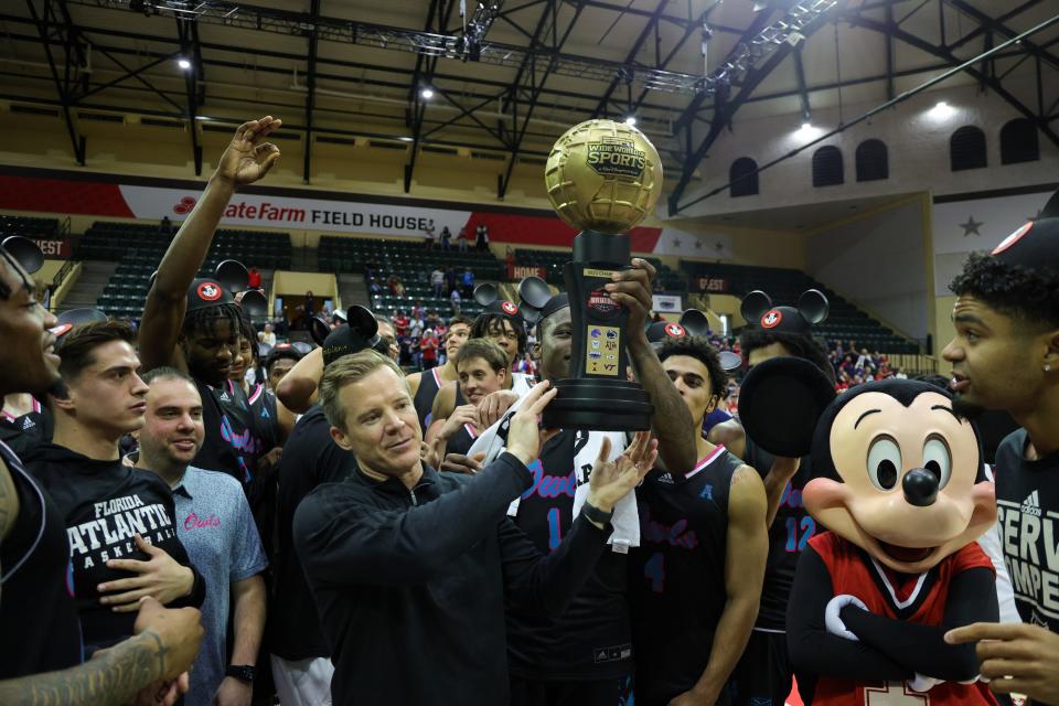 Nov 26, 2023; Kissimmee, FL, USA; Florida Atlantic Owls head coach Dusty May is presented the ESPN Events Invitational Championship trophy after beating the Virginia Tech Hokies at State Farm Field House. Mandatory Credit: Nathan Ray Seebeck-USA TODAY Sports