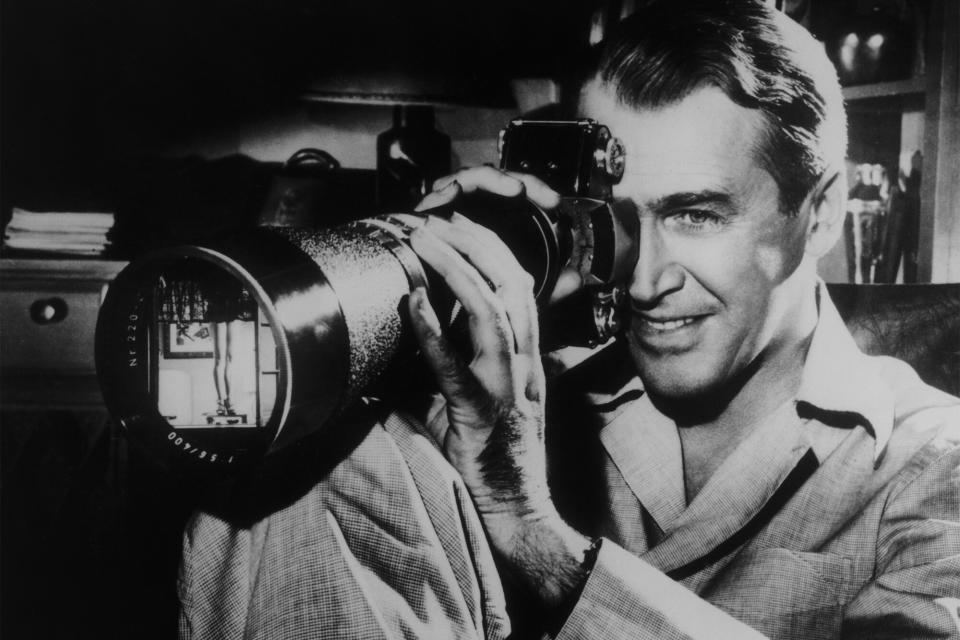 American actor James Stewart (1908 - 1997) focuses on a shapely pair of female legs in a scene from the film 'Rear Window', directed by Alfred Hitchcock for Paramount, 1954. (Photo by Paramount Pictures/Archive Photos/Getty Images)