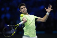 Spain's Carlos Alcaraz returns the ball to Russia's Daniil Medvedev during their singles tennis match of the ATP World Tour Finals at the Pala Alpitour, in Turin, Italy, Friday, Nov. 17, 2023. (AP Photo/Antonio Calanni)