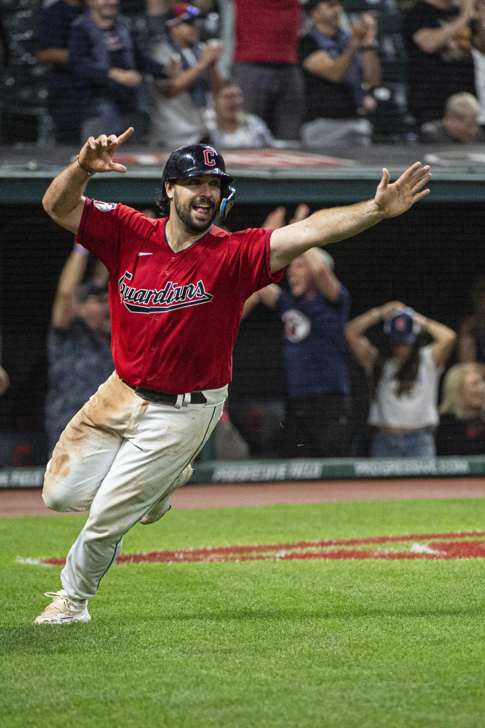 Cleveland Guardians' Austin Hedges reacts after scoring the winning run against the Minnesota Twins in the 15th inning of the second game of a baseball doubleheader in Cleveland, early Sunday, Sept. 18, 2022. (AP Photo/Phil Long)