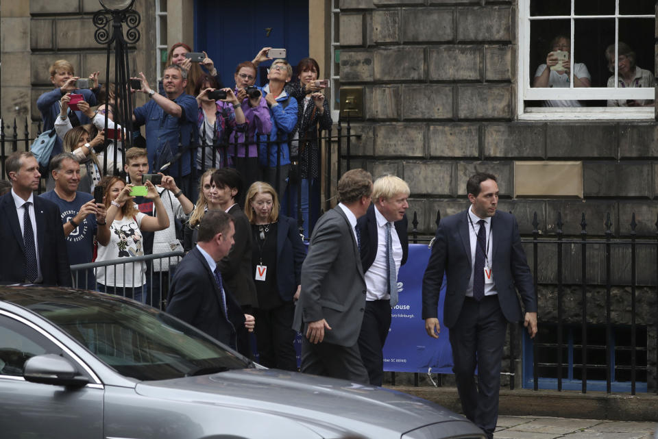 Britain's Prime Minister Boris Johnson arrives to meet Scotland's First Minister Nicola Sturgeon, outside Bute House, ahead of their meeting, in Edinburgh, Scotland, Monday July 29, 2019. Johnson made his first official visit as British prime minister to Scotland, pledging to boost "the ties that bind our United Kingdom" amid opposition from Scottish leaders to his insistence on pulling Britain out of the European Union with or without a deal. (Jane Barlow/PA via AP)