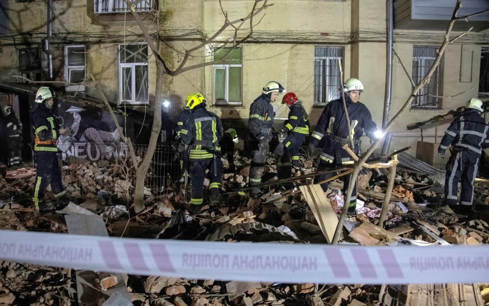 Rescuers work at the site where an apartment building was heavily damaged by a Russian missile strike - STRINGER/REUTERS