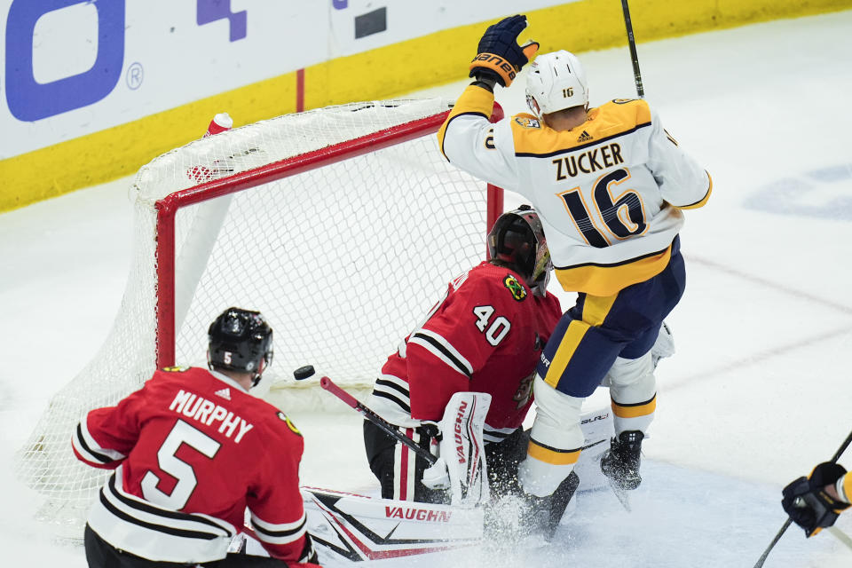 Nashville Predators left wing Jason Zucker, right, scores on Chicago Blackhawks goaltender Arvid Soderblom during the second period of an NHL hockey game Friday, April 12, 2024, in Chicago. (AP Photo/Erin Hooley)