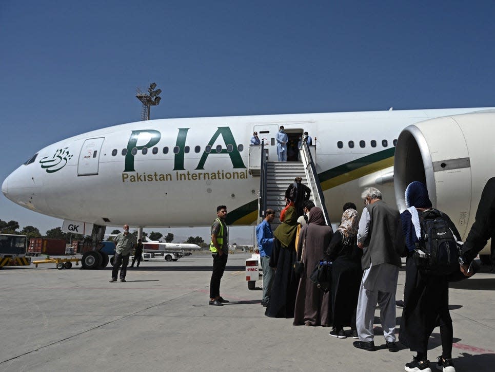 Passengers board a Pakistan International Airlines flight in Kabul