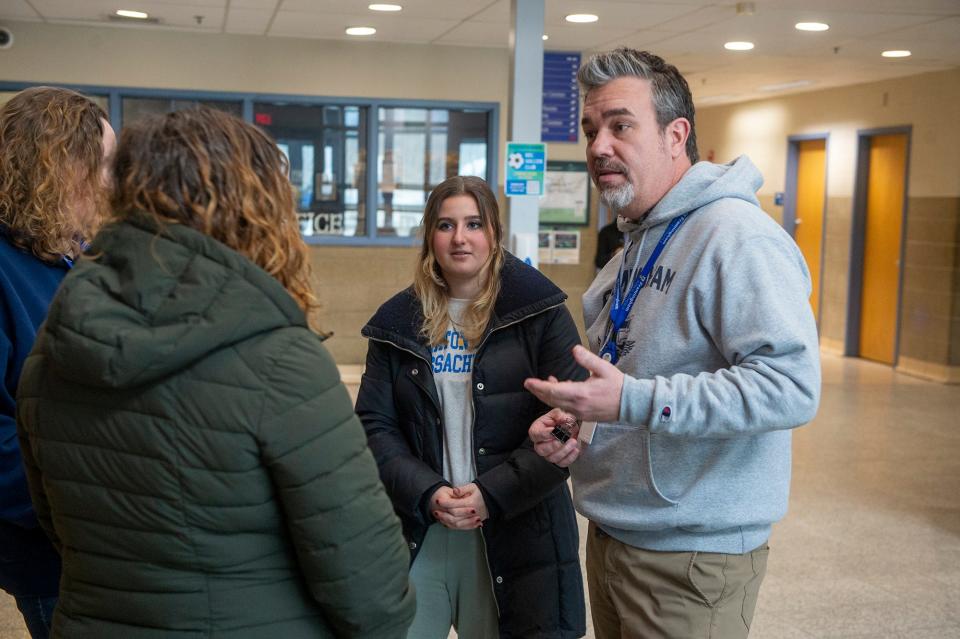 Framingham Supt. of Schools Robert Tremblay speaks with Framingham High School senior Emma Tessitore in the high school lobby, Feb. 23, 2023. The high school has been open during February vacation week for counseling in the aftermath of the false alarm for an active shooter in the building last Friday.