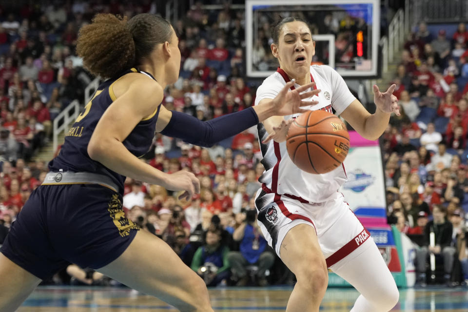 NC State's Mimi Collins, right, and Notre Dame's Natalija Marshall, left, battle for a loose ball during the first half of an NCAA basketball game for the Women's Atlantic Coast Conference championship in Greensboro, N.C., Sunday, March 10, 2024. (AP Photo/Chuck Burton)