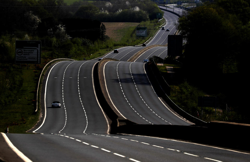 A nearly empty A23 in Slaugham, England, near Brighton due to the coronavirus outbreak and following lockdown on Saturday, April 11, 2020. The new coronavirus causes mild or moderate symptoms for most people, but for some, especially older adults and people with existing health problems, it can cause more severe illness or death.(AP Photo/Frank Augstein)